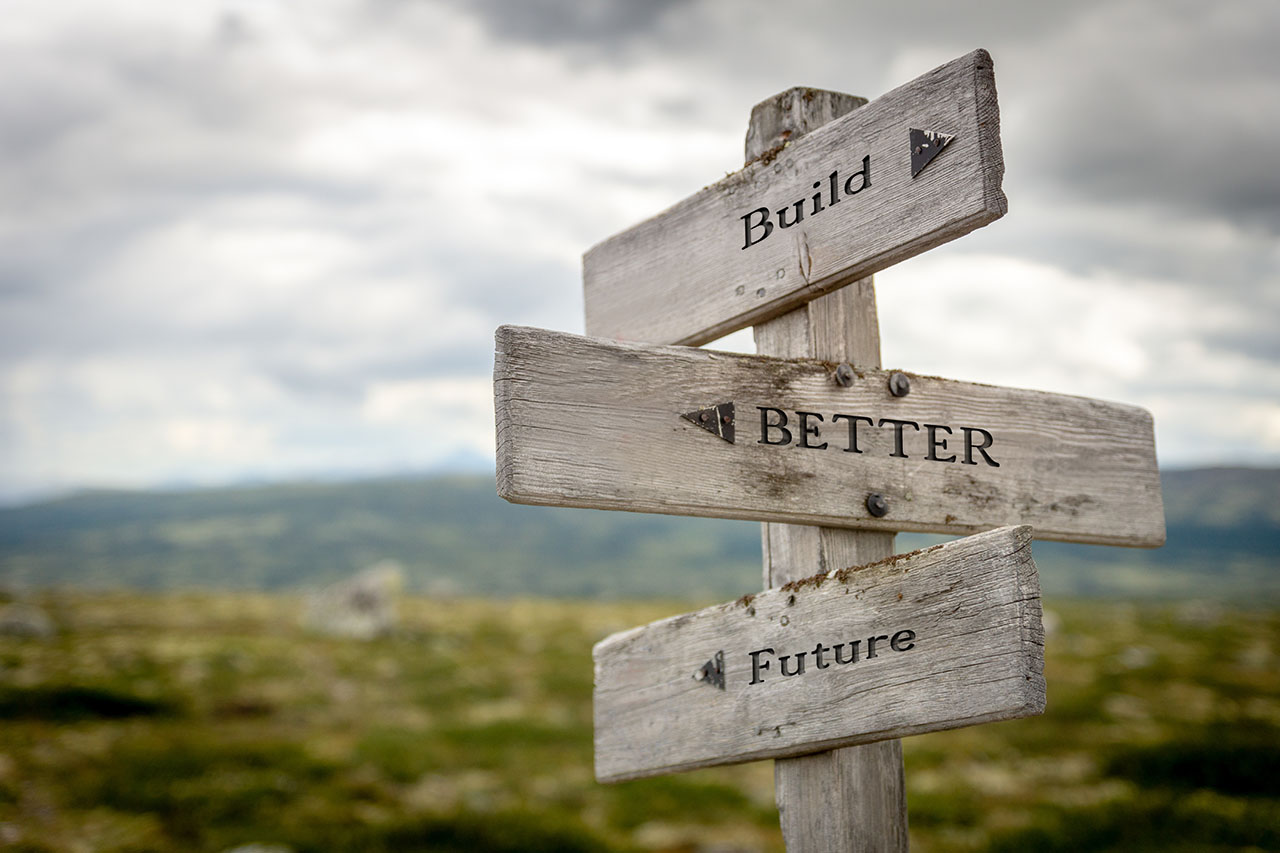 build better future text on wooden signpost outdoors in nature